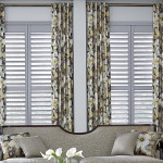 Graber Wood Shutters and drapes in living room