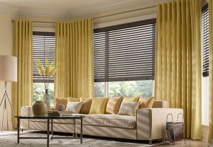 Blinds and drapes covering living room windows
