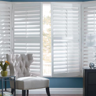 Home window decorated with white interior shutters